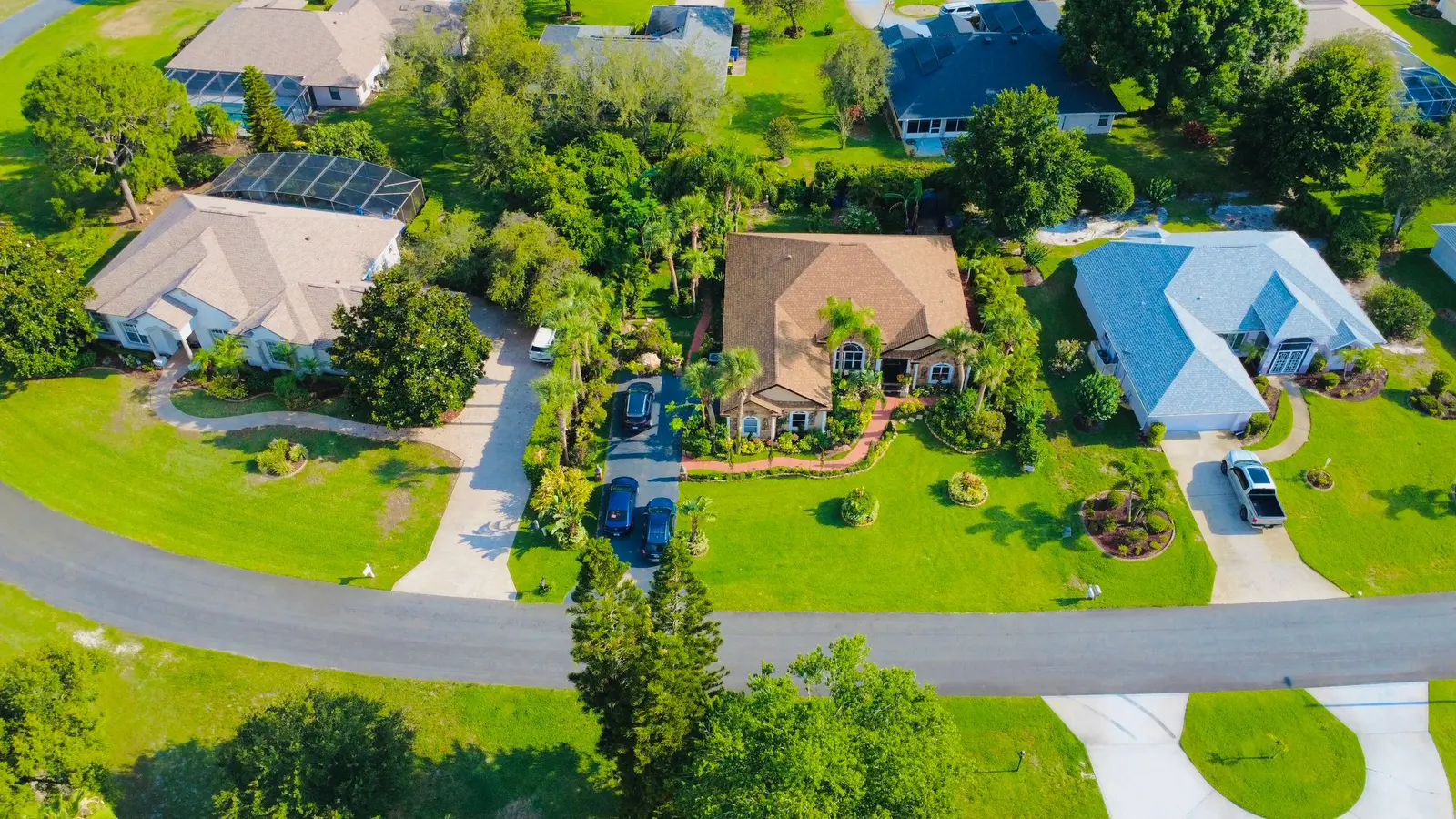 Aerial view of a green Florida neighborhood with winding streets